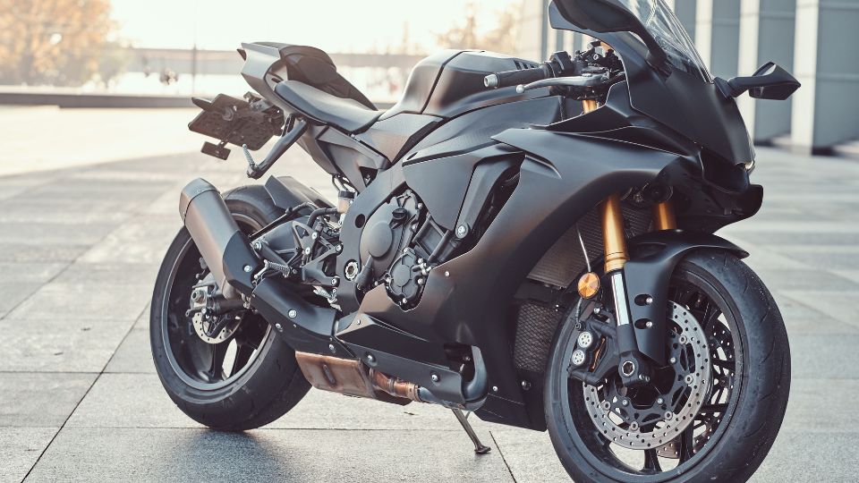 Fekete superbike, modern dizájnnal, városi környezetben.